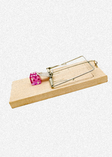 A mouse trap loaded with a die